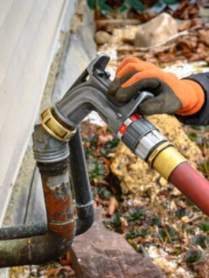 Same-day heating oil delivery hose and nozzle at a Patchogue, NY home